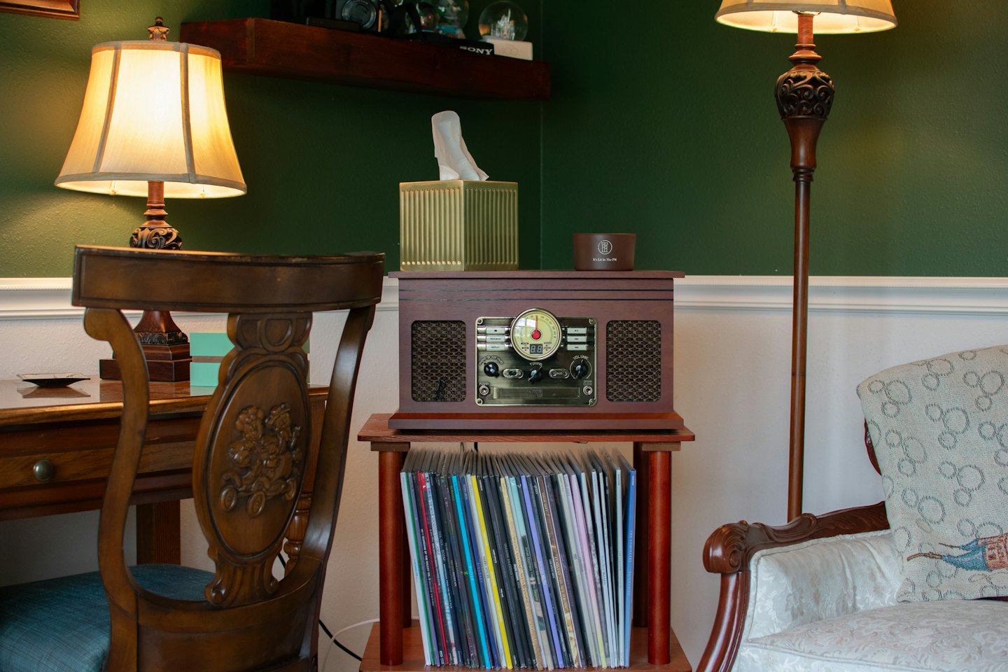 Retro stereo and vinyl records sit on a wooden stand.